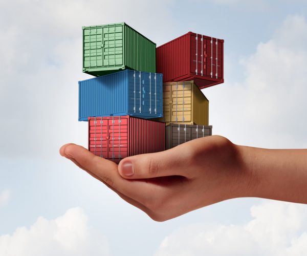 Cargo shipping support concept as a hand holding a group of freight containers as a transport and logistics or commerce metaphor with 3D illustration elements.